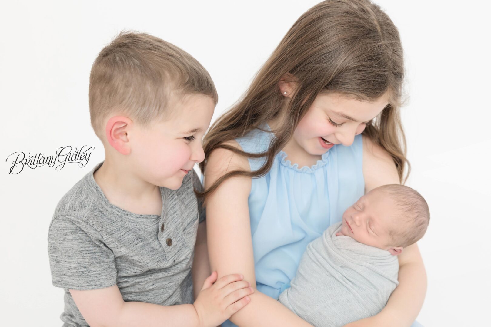Siblings With Newborn Baby