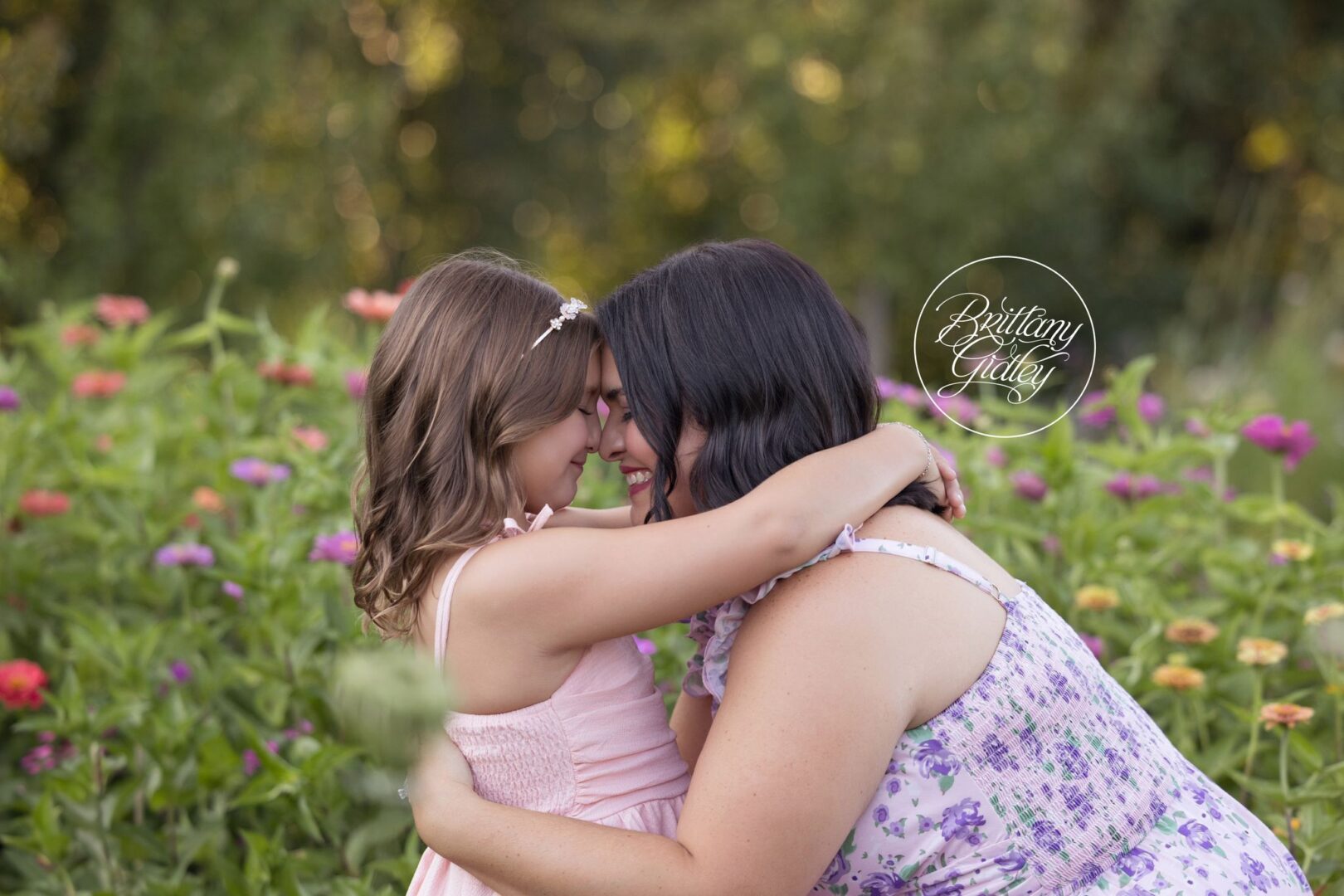 Daughter and mom nose to nose in a field of zinnias, Akron first birthday photographer