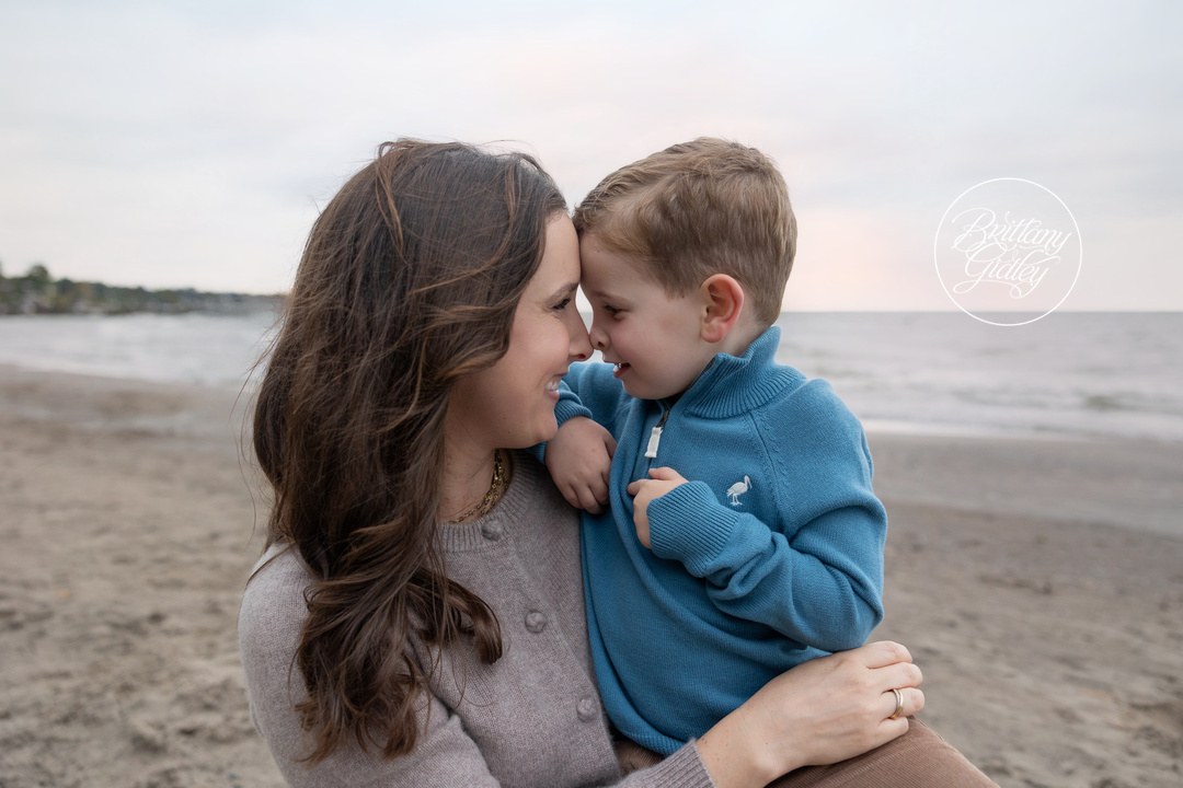 Mom and her son touching noses and smiling on Huntington Beach in Bay Village