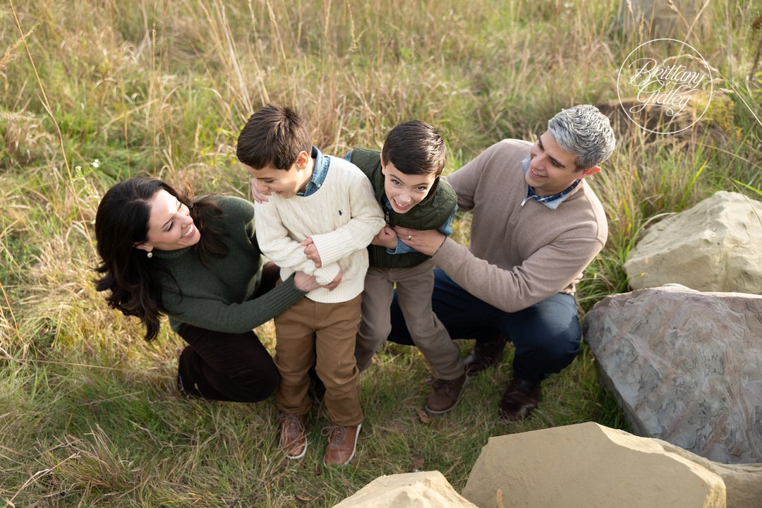 Mom and Dad tickling their two boys during a fall family session in Brecksville