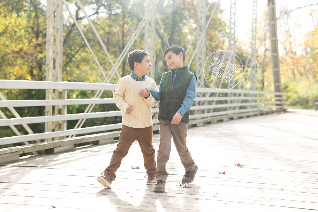 Brothers walking and laughing together across a bridge at Brecksville Reservation