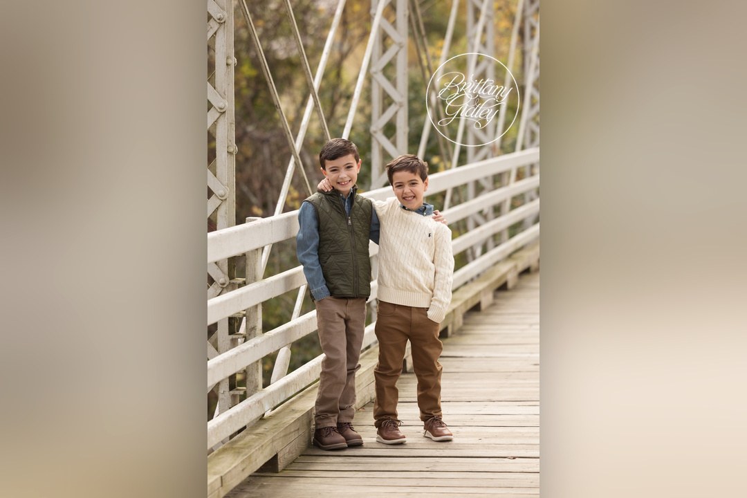 Two brothers standing arm in arm on the bridge at Brecksville Reservation
