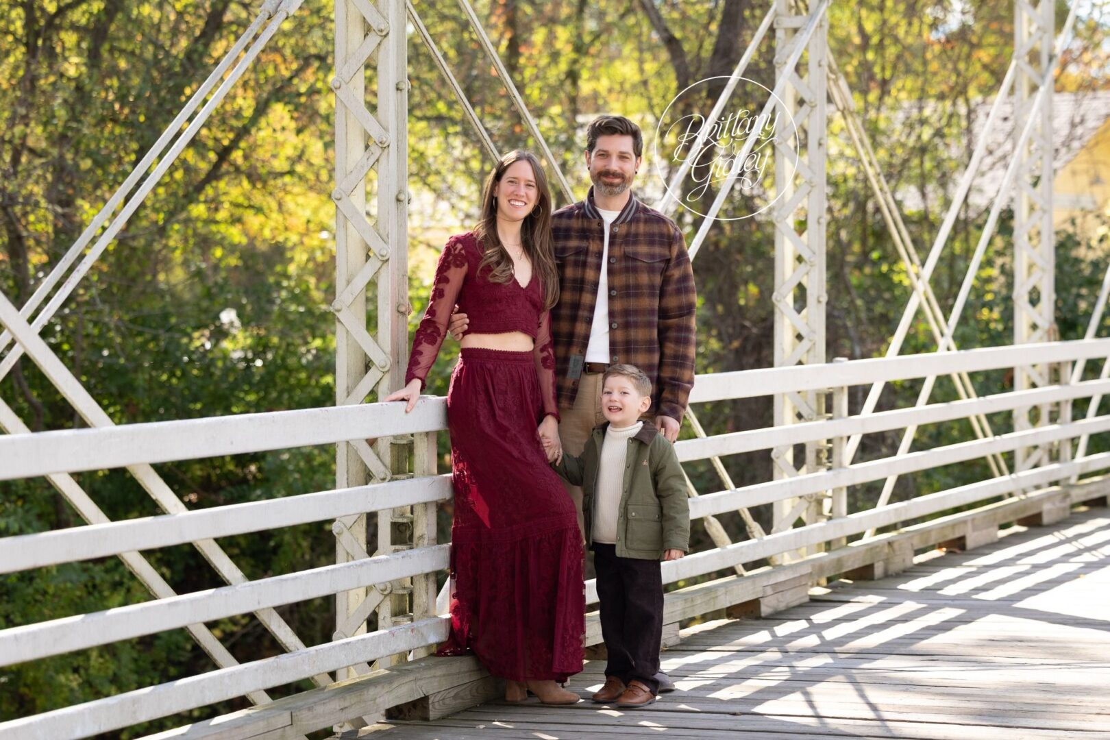 Wilson family of three on the white bridge at Brecksville Reservation in fall