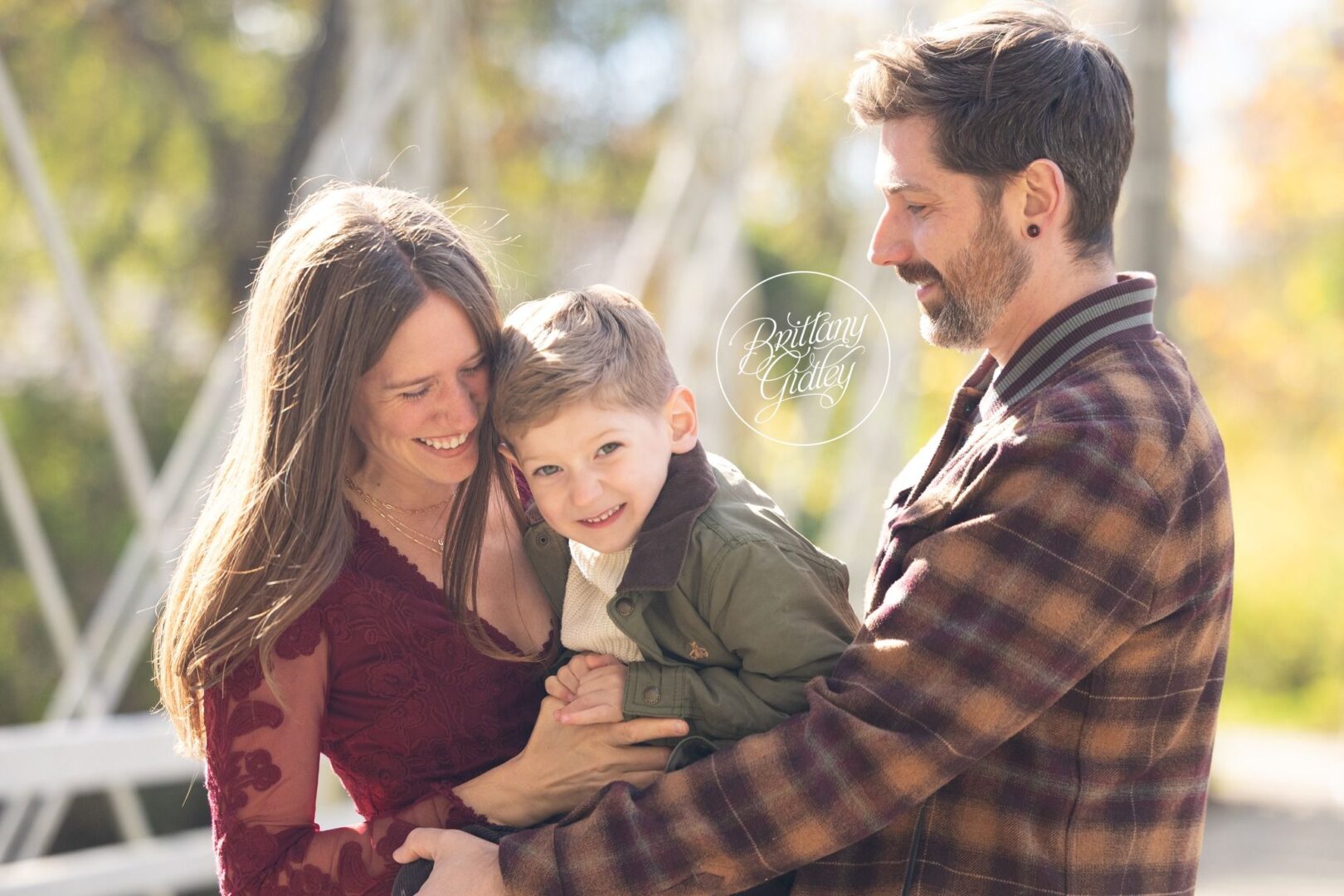 Mom and Dad cuddling their little boy on the bridge, Brecksville Reservation family photos