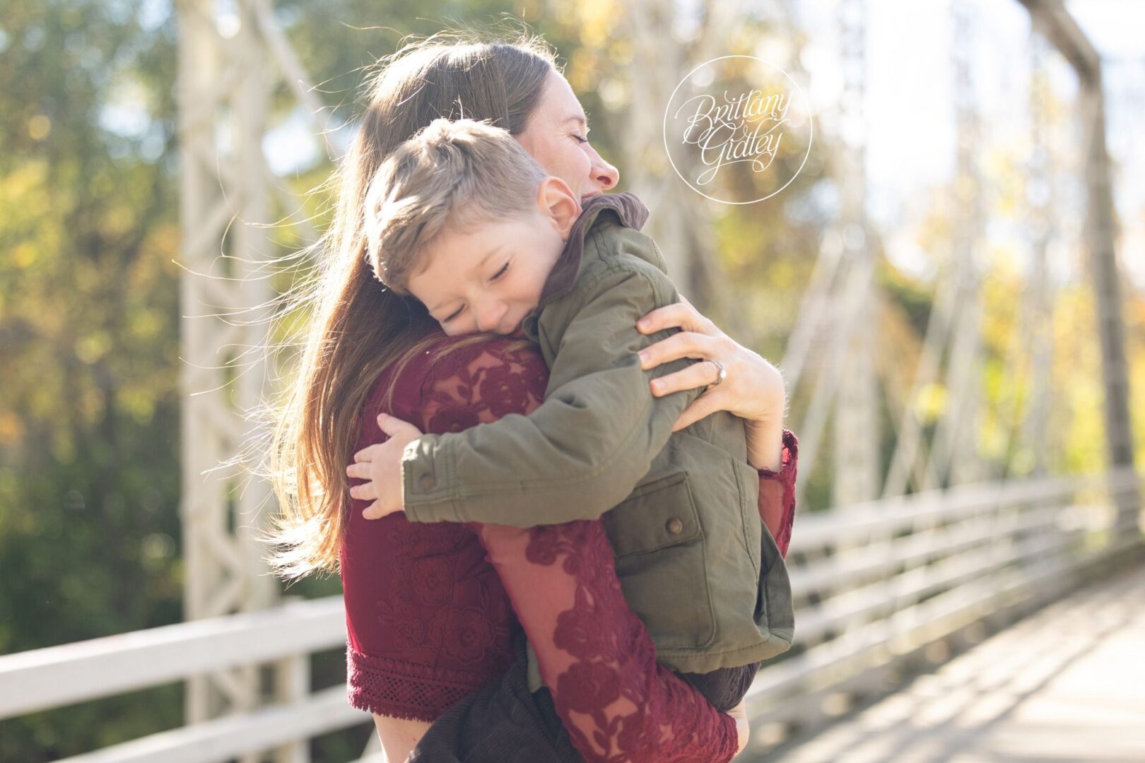 Mom hugging her son tight on the bridge at Brecksville Reservation