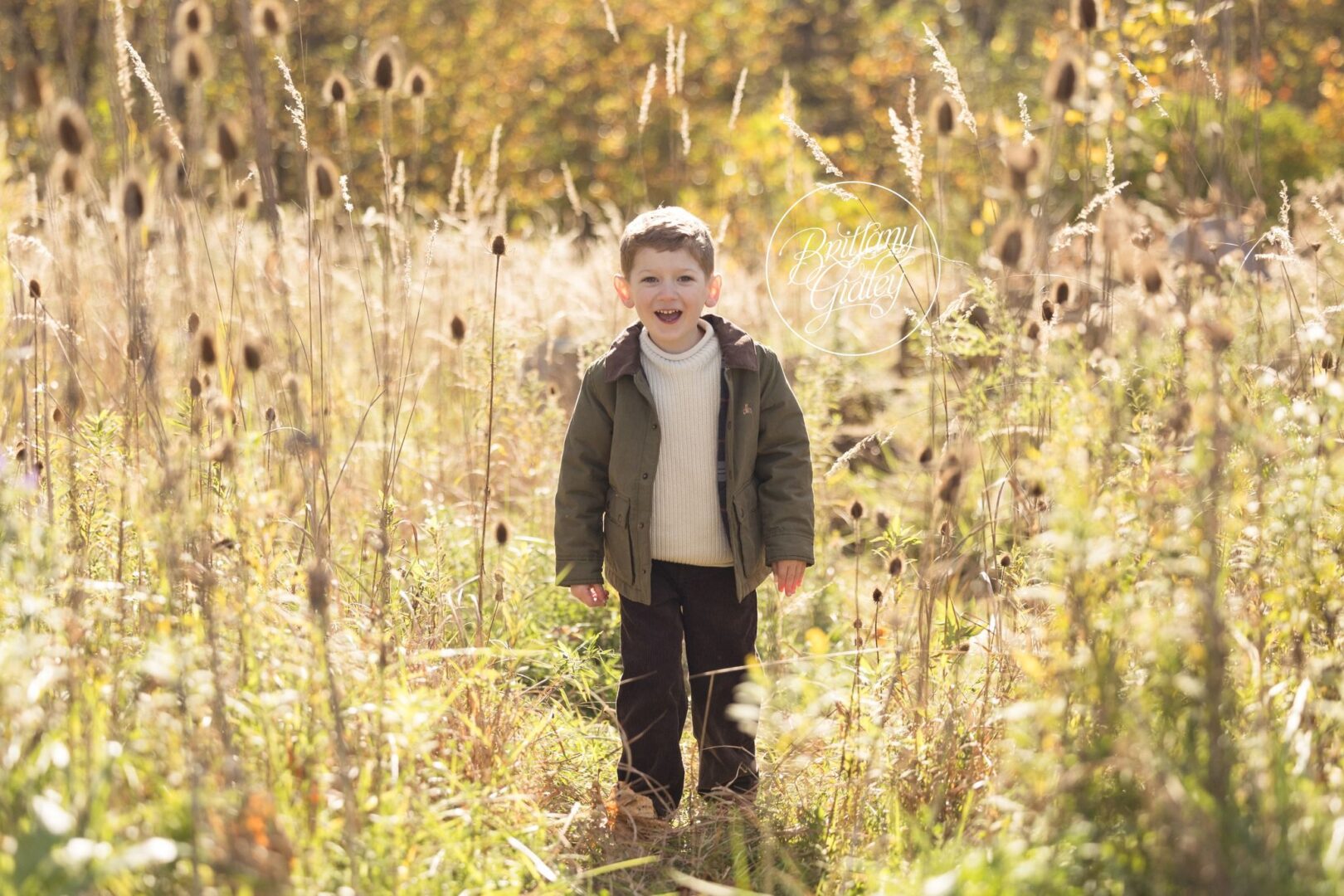 Little boy standing in tall grass and teasels at Brecksville Reservation