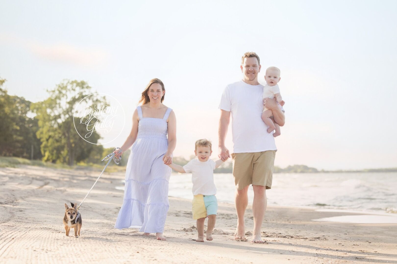 Family walking on the beach with Miles, Nolan and their dog Poppy
