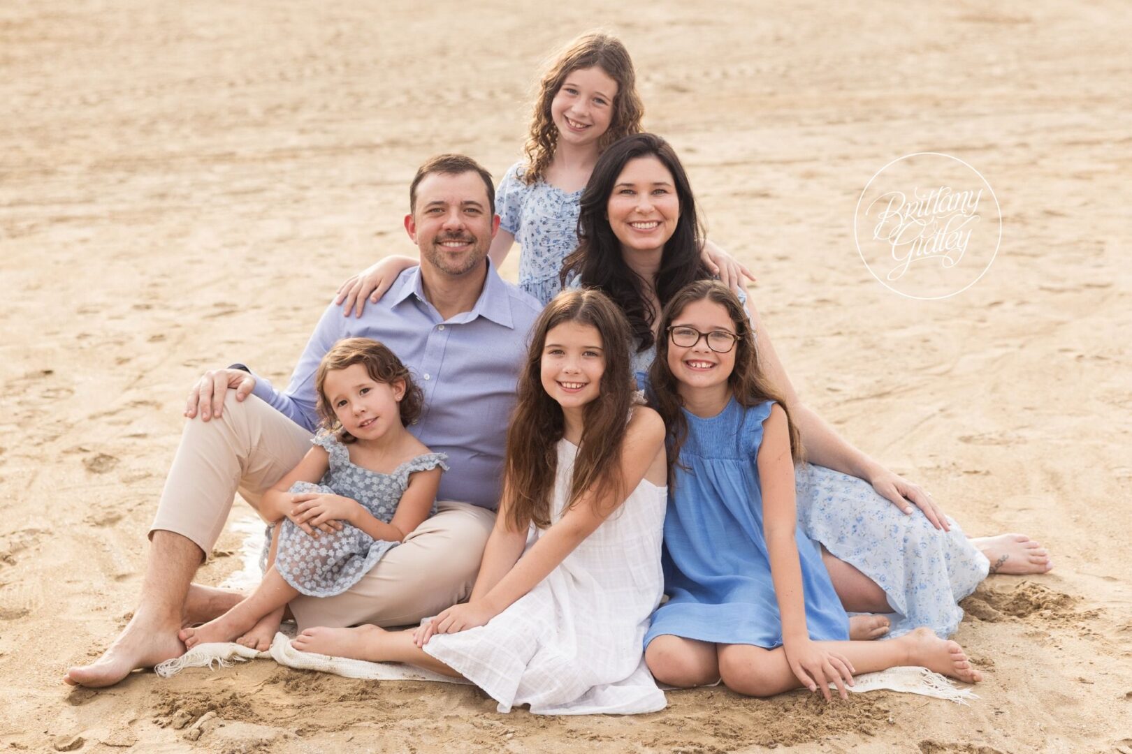 Lindow family sitting together on the sand at Edgewater Beach in Cleveland