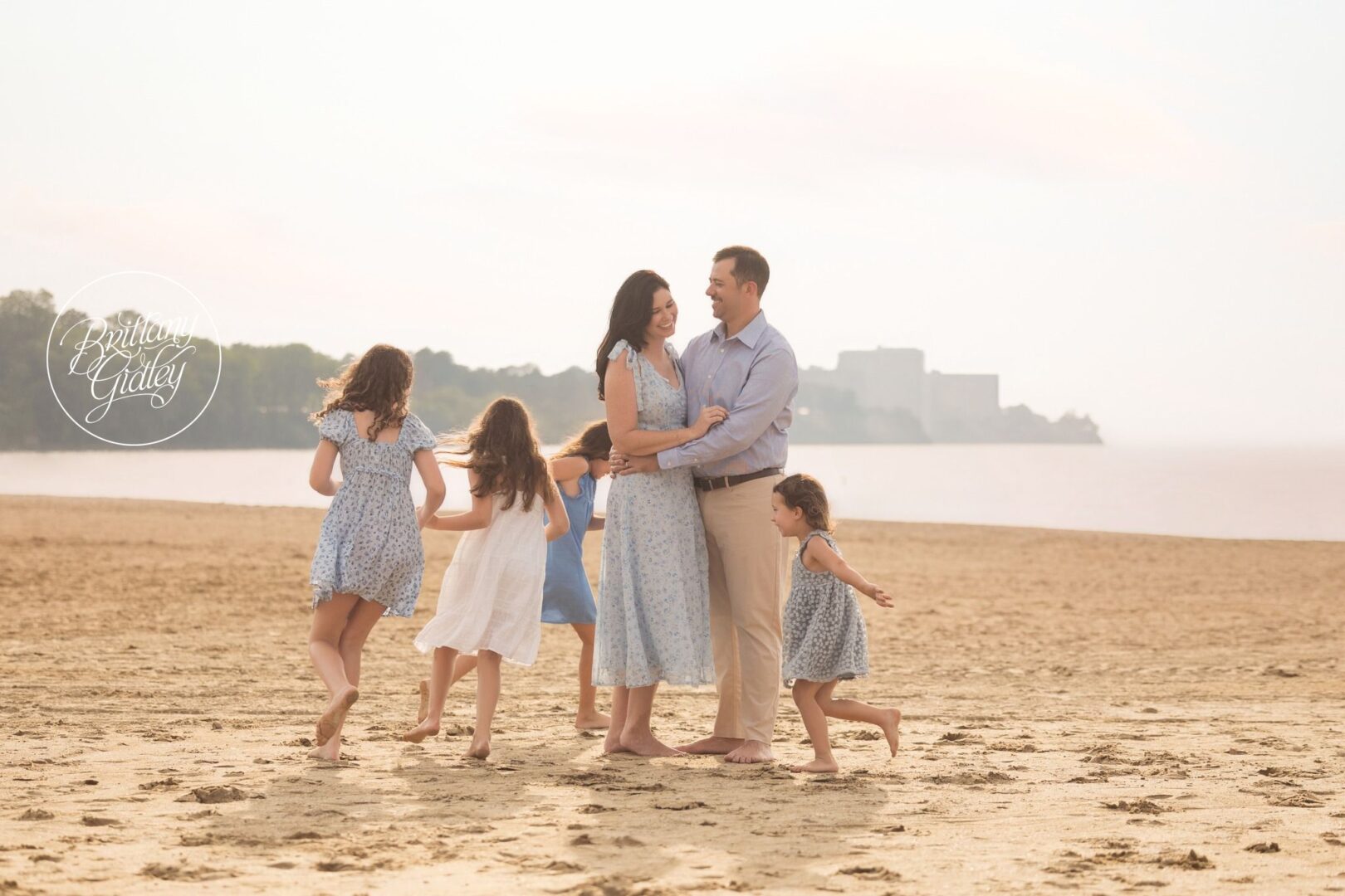 Lindow family playing on the beach with the Cleveland skyline behind them