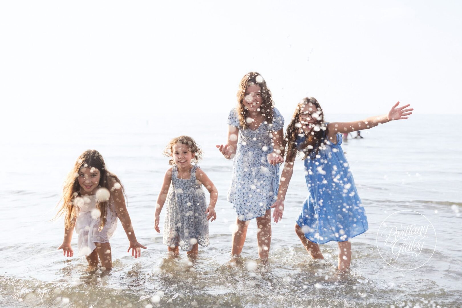 Sisters splashing in the water at Edgewater Beach