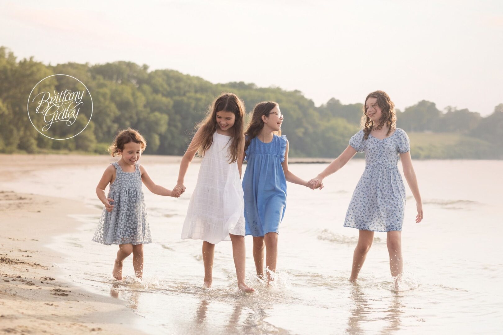 Sisters walking hand in hand along the Lake Erie shoreline