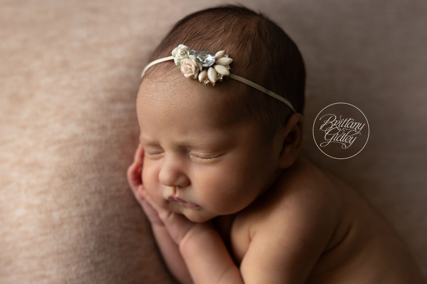 Close-up of newborn Isabel sleeping with her hands tucked under her cheeks