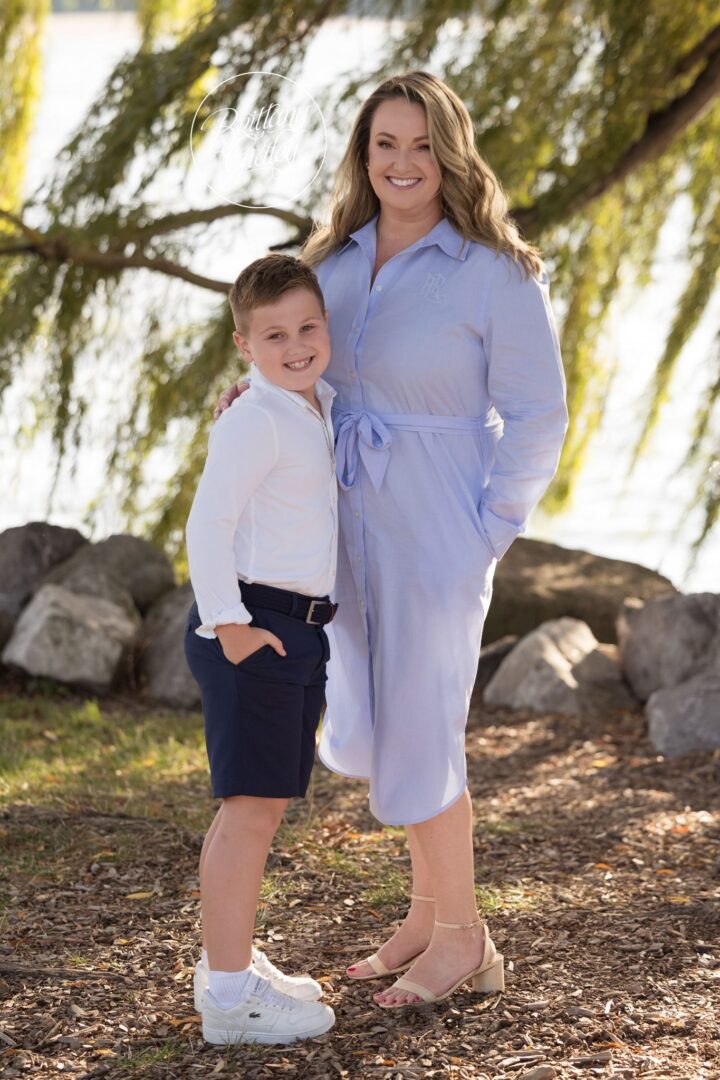 Mom and her son standing together under the willow at Edgewater Park
