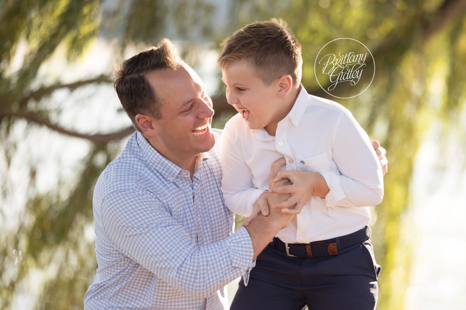 Dad and son laughing together during a family session at Edgewater Beach