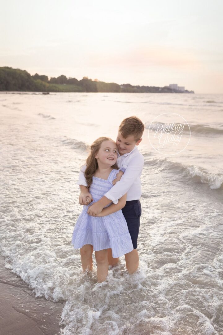 Brother hugging his sister in the Lake Erie waves at Edgewater Beach