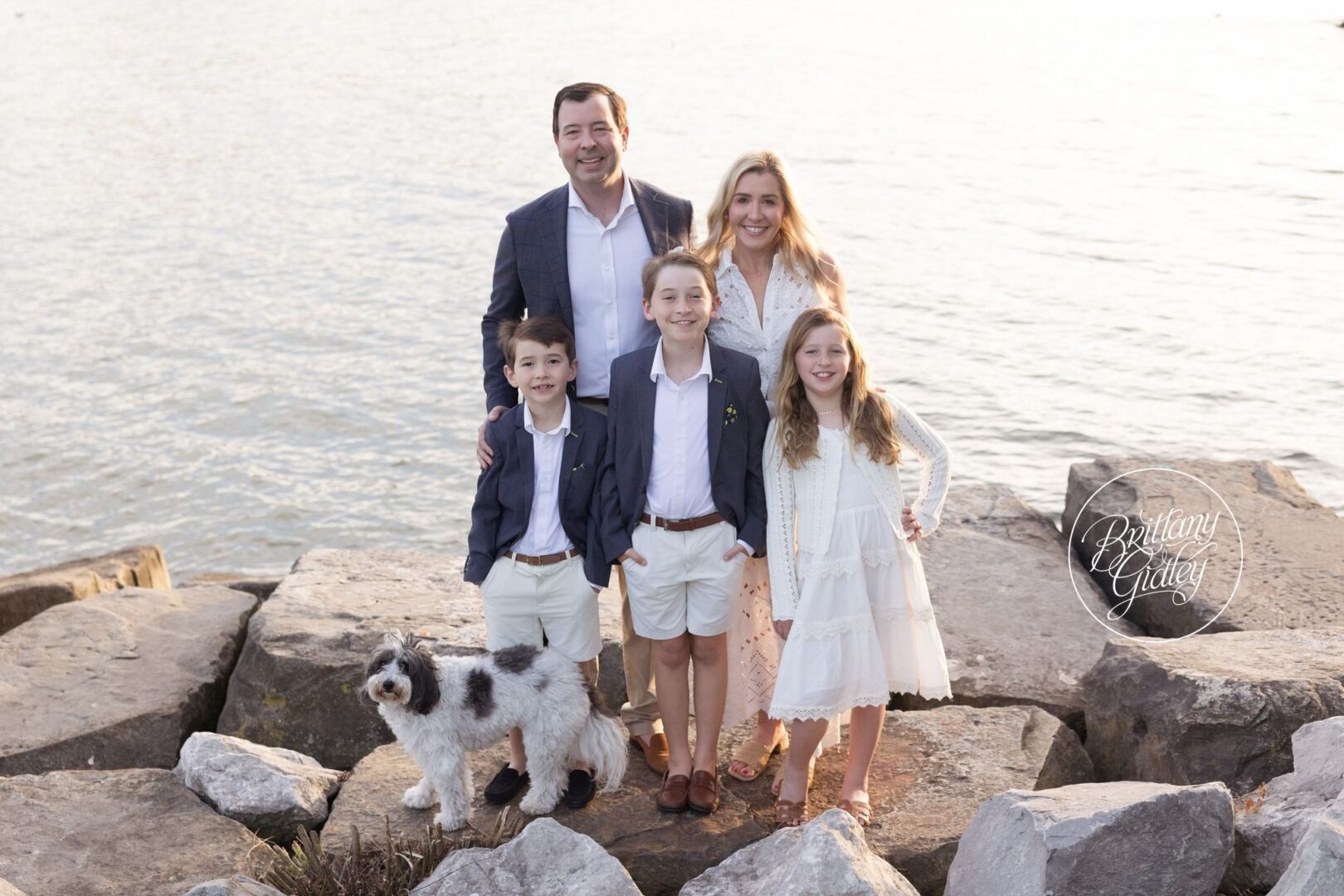 Mitchell family with their dog Lulu on the rocks along Lake Erie