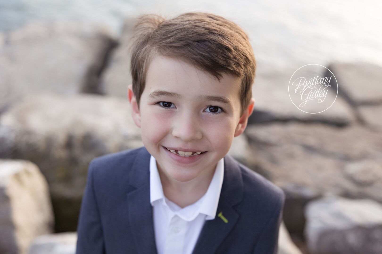 Younger brother grinning in a navy blazer at Edgewater Beach