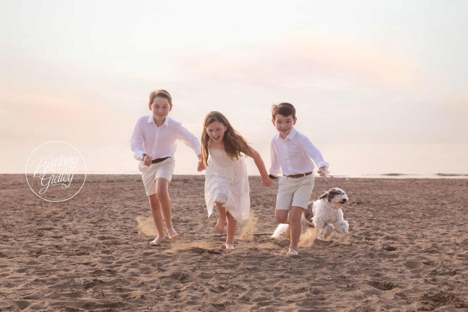 Kids running across the sand with Lulu at Edgewater Beach