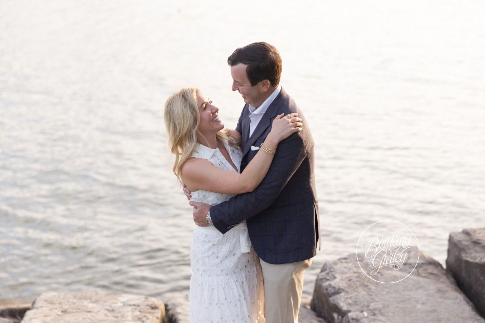 Mom and Dad embracing by the water at Edgewater Beach
