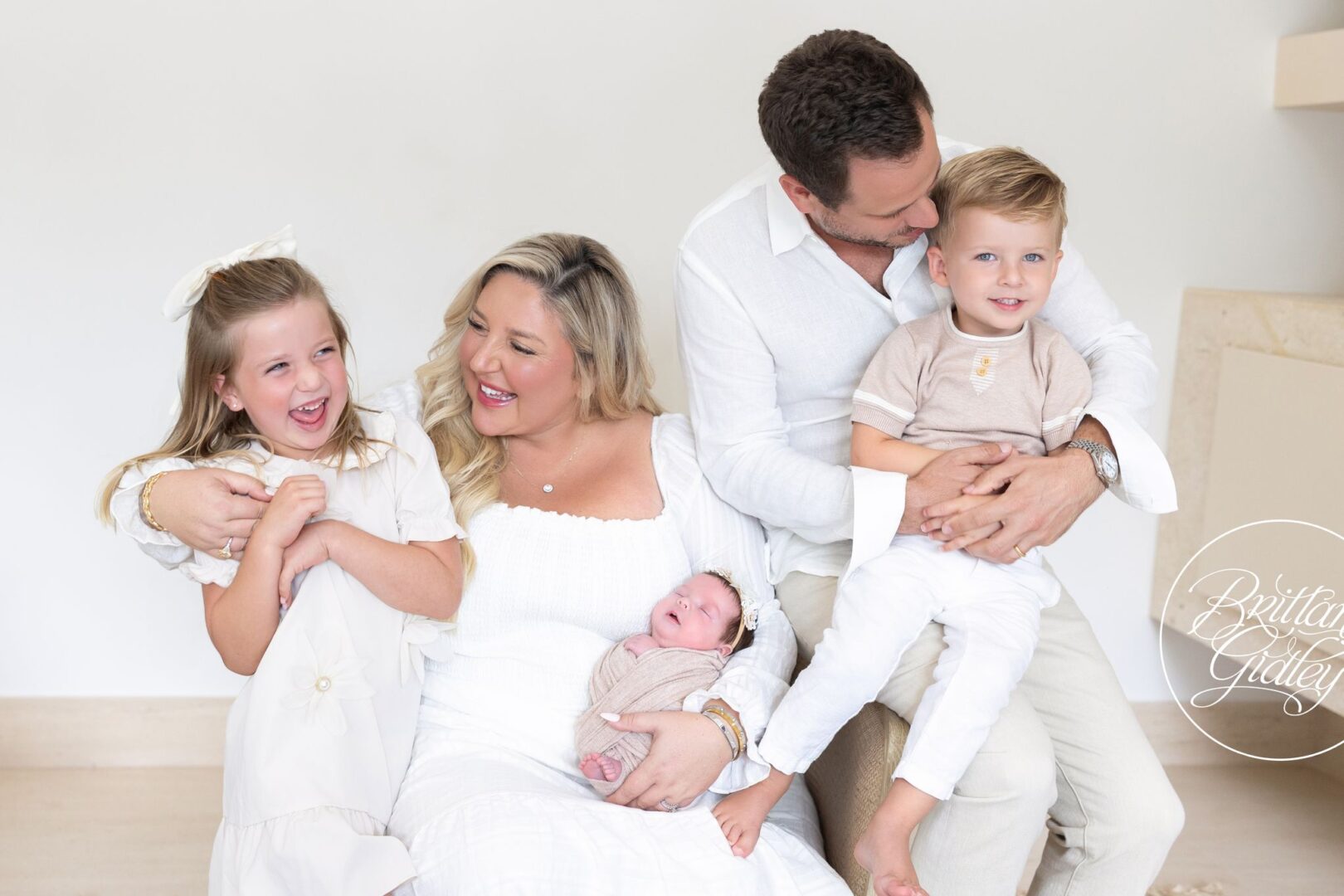 Family with newborn Lillian, big sister and big brother, dressed in white in Naples, Florida