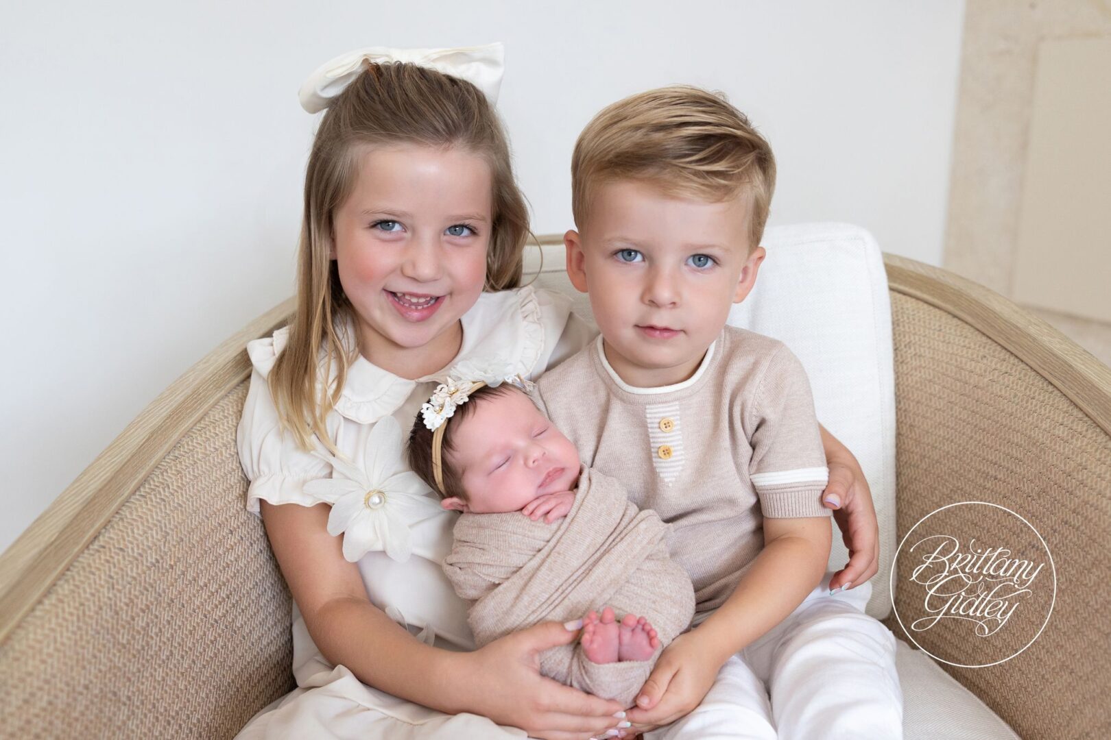 Big sister and big brother holding their newborn baby sister, Naples Florida newborn photographer