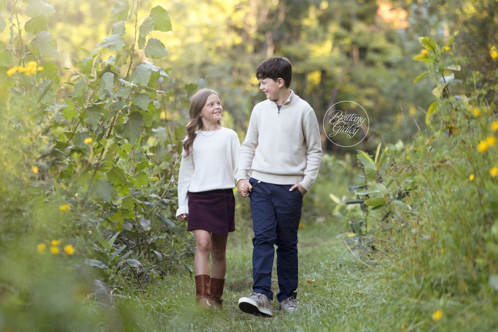 Brother and sister walking together down a meadow path, Northeast Ohio family photographer